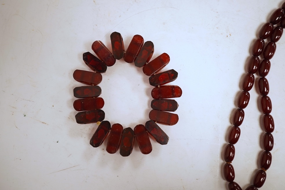 A single strand graduated oval simulated amber bead necklace, 72cm, gross weight 64 grams, together with a simulated cherry amber bracelet.
